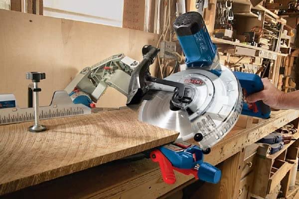 Cutting a piece of wood with the 12 inch miter saw